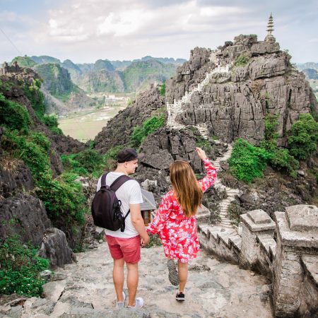 Beautiful,young,just,married,couple,jump,together,on,the,steps