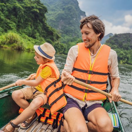 Happy Family Tourists In Trang An Scenic Landscape Complex In Ninh Binh Province, Vietnam A Unesco World Heritage Site. Resumption Of Tourism In Vietnam After Quarantine Coronovirus Covid 19